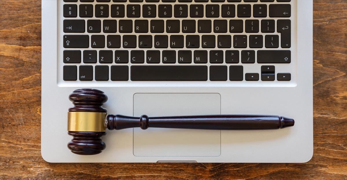 laptop with internet law gavel on wood table